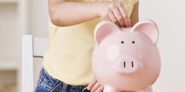 Man putting money in a piggy bank