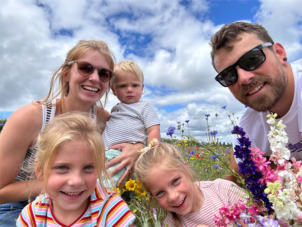 Ben, Tabitha, Isla, Jemima and George in a field of flowers on a summers day.