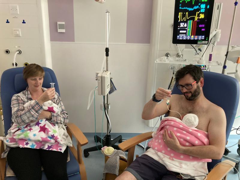 Emily O'Brien and husband feeding their twin girls in neonatal care