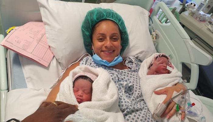 A woman with her newborn twins. 