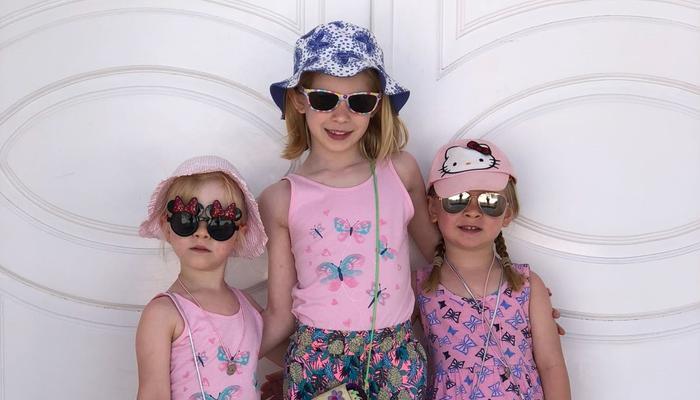 Twins and older sister dressed for summer