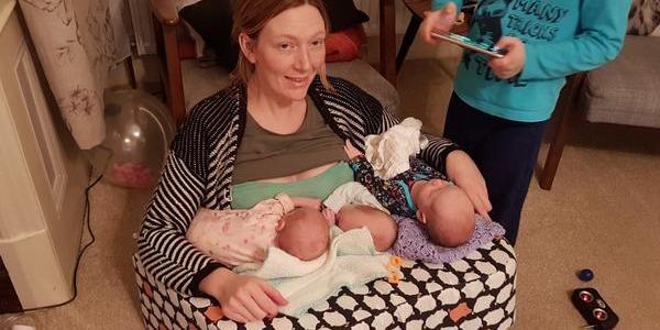 Mother breastfeeding triplets