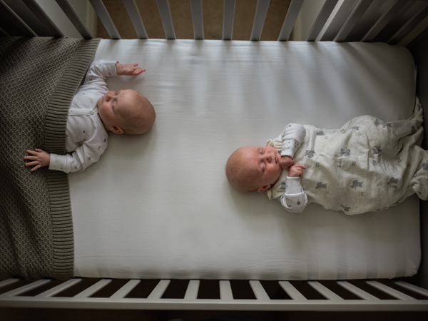 Twins co-sleeping in the feet-to-foot position