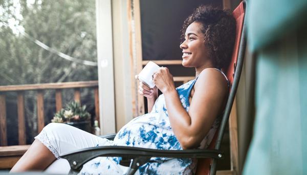 A pregnant woman relaxing outside