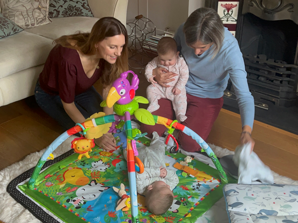 Kate and Gemma play with twins on a floor play mat