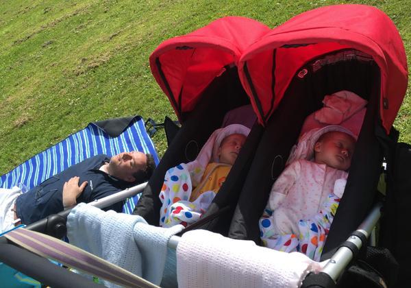 Twin babies sleeping in buggy