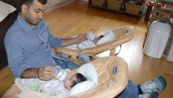 Dad bottle feeding twins