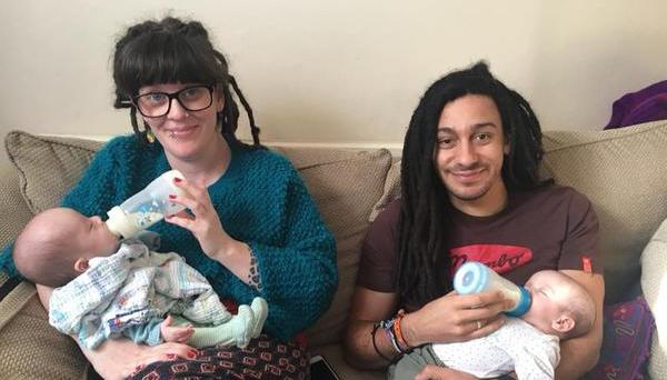 Mum and dad bottle feeding twin babies