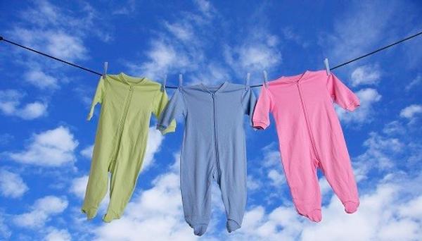 Three sleepsuits hanging from a washing line
