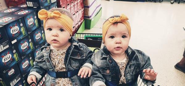 Twin girls in shopping trolley