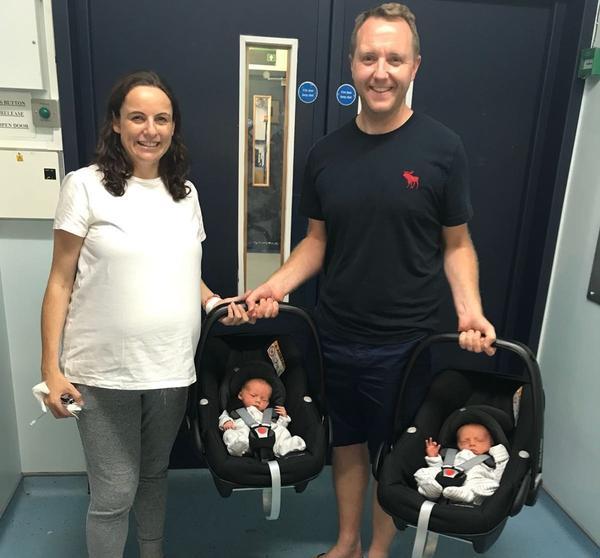 Parents leaving hospital with their twins