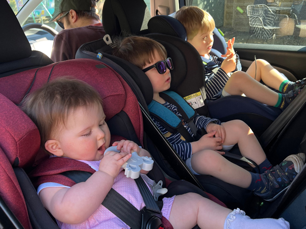 Triplets sit in rear-facing car seats