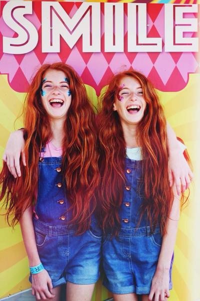 Twin girl teenagers laughing