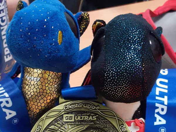 Two blue dragons with one of Alun's Ultra 50 gold medals